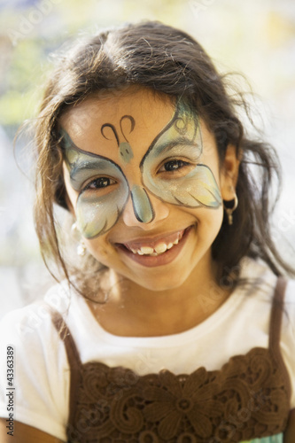 Photo: Close up of Hispanic girl with butterfly painted on face Close up of Hispanic girl with butterfly painted on face