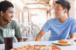 Friends eating pizza in restaurant