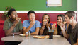 Friends eating pizza together in restaurant