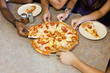 Friends eating pizza together in restaurant
