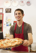 Caucasian teenager working in pizza restaurant