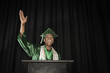 Mixed race high school graduate speaking at podium