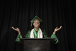 Mixed race high school graduate speaking at podium