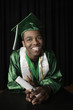 Mixed race high school graduate standing at podium with diploma