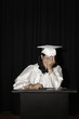 Embarrassed Hispanic high school graduate speaking at podium