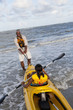 Black grandfather going kayaking with granddaughter
