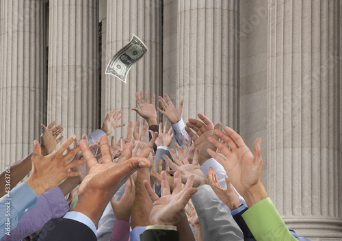 Photo: Crowd stretching hands up to catch falling one dollar bill Crowd stretching hands up to catch falling one dollar bill