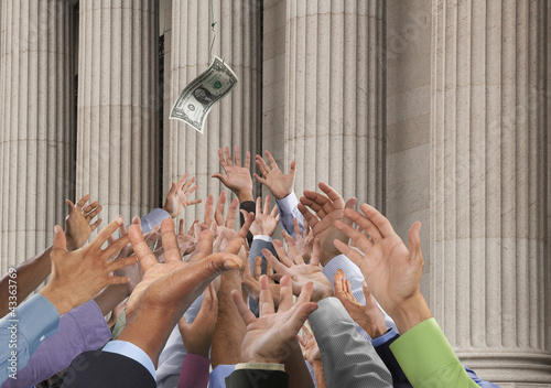 Photo: Crowd stretching hands up to catch falling one dollar bill Crowd stretching hands up to catch falling one dollar bill