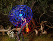 Black woman making blue and red light streaks in air