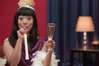 Elegant Asian woman drinking Champagne on New Year's Eve