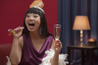 Elegant Asian woman drinking Champagne on New Year's Eve