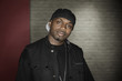Black man in vest and baseball cap