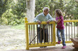 Grandfather talking to granddaughter on porch