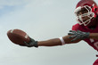 Black football player catching football
