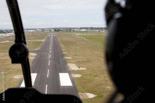 Photo: Cockpit view of airplane landing on airport runway Cockpit view of airplane landing on airport runway