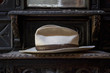 Close up of weathered fedora hat on shelf