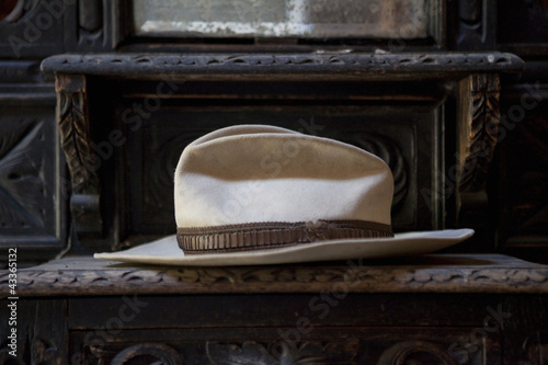 Photo: Close up of weathered fedora hat on shelf Close up of weathered fedora hat on shelf
