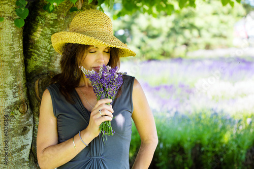 Photo: Woman smelling fresh lavender Woman smelling fresh lavender