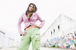 Hispanic woman standing in urban alley
