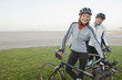 Caucasian woman standing with bicycles