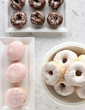 Frosted chocolate and strawberry donuts and donut holes, top view