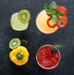 Photo: Array of alcoholic beverages with kiwi, bell pepper and blackberry garnishes, top view Array of alcoholic beverages with kiwi, bell pepper and blackberry garnishes, top view