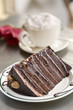 Extravagant chocolate cake served with whipped cream topped coffee 