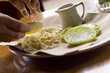Applying breading to green tomatoes before frying