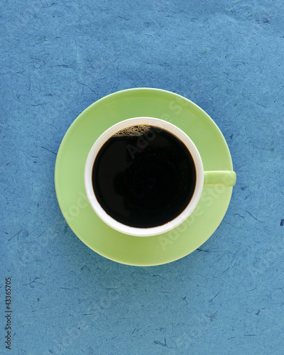 Photo: Full coffee cup and saucer, top view Full coffee cup and saucer, top view
