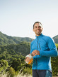 Photo: Athletic mixed race man drinking water outdoors Athletic mixed race man drinking water outdoors
