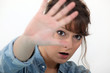 Woman hiding her face with her hand