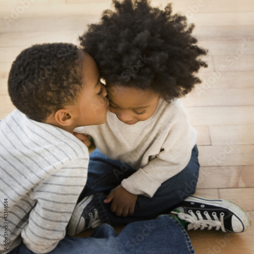 Photo: African American boy kissing brother African American boy kissing brother