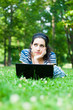 Beautiful young woman  using her laptop outdoors
