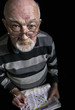 Photo: Old man solving crossword puzzle Old man solving crossword puzzle