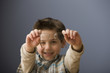Caucasian boy holding eyeglasses
