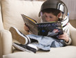 Caucasian boy reading book about space