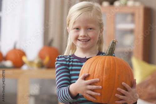 Photo: Caucasian girl holding pumpkin Caucasian girl holding pumpkin