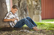 Caucasian boy whittling stick