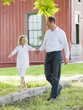 Caucasian father and daughter holding hands