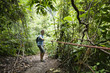 Caucasian man pulling rope in jungle