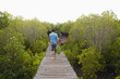 Caucasian man walking on wooden boardwalk