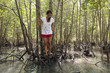 Hispanic woman stranded on tree roots