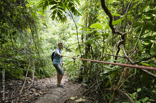 Photo: Caucasian man pulling rope in jungle Caucasian man pulling rope in jungle