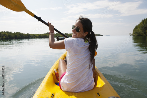 Photo: Hispanic woman paddling kayak Hispanic woman paddling kayak