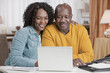 African American couple using laptop together
