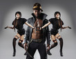 Trendy, tattooed African American man with two women