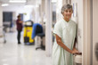 Caucasian patient leaning on railing in hospital