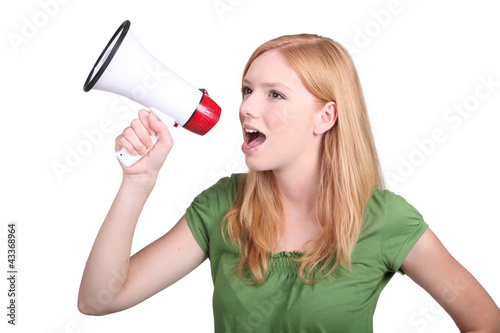 Photo: Young woman with a loudspeaker Young woman with a loudspeaker