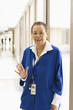 Hospital worker waving in corridor