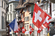 Old street in Zurich decorated with flags